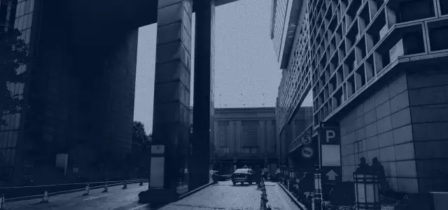 downtown photo among buildings looking at a car in distance